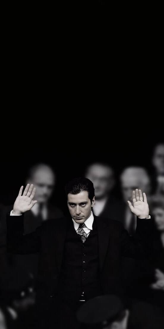 Michael Corleone's intense gaze and hands-raised gesture dominate this powerful black and white 4K wallpaper, perfectly capturing a dramatic moment from The Godfather Part II. This compelling wallpaper is ideal for any iPhone screen, showcasing Al Pacino's iconic role. | artist Michael Corleone's intense gaze and hands-raised gesture dominate this powerful black and white 4K wallpaper, perfectly capturing a dramatic moment from The Godfather Part II. This compelling wallpaper is ideal for any iPhone screen, showcasing Al Pacino's iconic role.