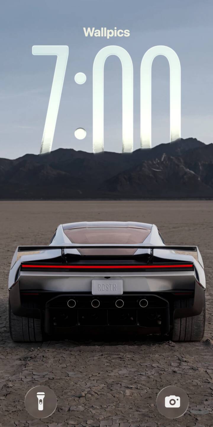 The striking red taillight strip glows vividly on the sleek white ROSTR sports car, parked in a vast, cracked desert landscape under imposing dark mountains in this stunning 4K wallpaper. This dynamic rear-view car wallpaper is perfect for any iPhone. | car sports car desert vehicle iphone minimalist wallpaper futuristic mobile 4k wallpaper hd wallpaper rostr The striking red taillight strip glows vividly on the sleek white ROSTR sports car, parked in a vast, cracked desert landscape under imposing dark mountains in this stunning 4K wallpaper. This dynamic rear-view car wallpaper is perfect for any iPhone.