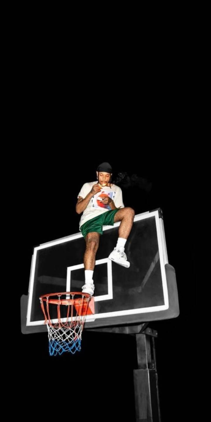 A person with a durag and green shorts is casually perched atop a basketball backboard, enjoying a snack against a stark black background in this striking 4K wallpaper. This truly unique and urban wallpaper is perfect for iPhone. | basketball A person with a durag and green shorts is casually perched atop a basketball backboard, enjoying a snack against a stark black background in this striking 4K wallpaper. This truly unique and urban wallpaper is perfect for iPhone.