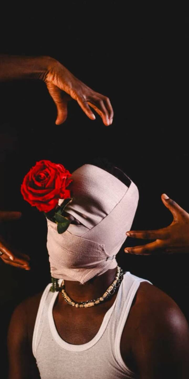 A striking red rose peeks from the bandaged head of a figure, with dark hands reaching from shadows in this captivating 4K wallpaper. This profound iPhone wallpaper features a blend of vulnerability and artistic depth. | flower A striking red rose peeks from the bandaged head of a figure, with dark hands reaching from shadows in this captivating 4K wallpaper. This profound iPhone wallpaper features a blend of vulnerability and artistic depth.
