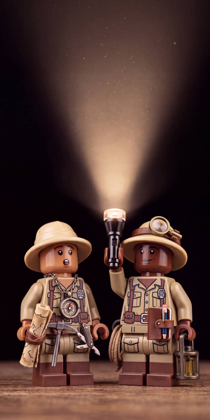 A bright flashlight beam cuts through the dusty darkness, highlighting two detailed Lego explorer minifigures equipped with a map, compass, and magnifying glass in this captivating 4K wallpaper. This adventurous wallpaper is perfect for any iPhone ready for discovery. | lego explorer iphone flashlight wallpaper dusty mobile 4k wallpaper hd wallpaper toy photography adventure lego minifigure A bright flashlight beam cuts through the dusty darkness, highlighting two detailed Lego explorer minifigures equipped with a map, compass, and magnifying glass in this captivating 4K wallpaper. This adventurous wallpaper is perfect for any iPhone ready for discovery.