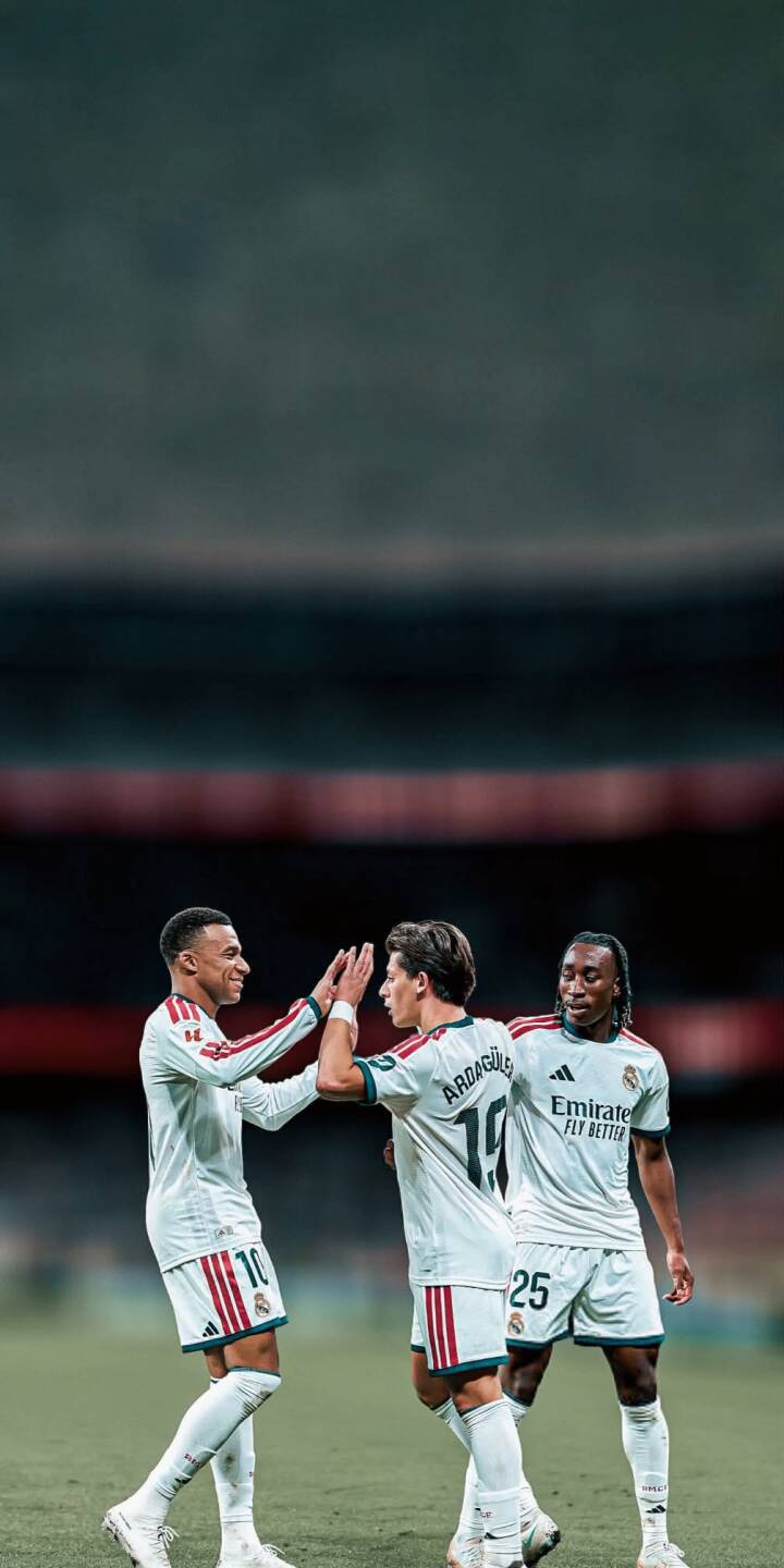 Three Real Madrid players in crisp white jerseys share a victorious high-five on the pitch, perfectly captured in this dynamic 4K wallpaper. This spirited team celebration makes an inspiring football wallpaper for iPhone screens. | sports football celebration iphone soccer team real madrid wallpaper players mobile 4k wallpaper hd wallpaper Three Real Madrid players in crisp white jerseys share a victorious high-five on the pitch, perfectly captured in this dynamic 4K wallpaper. This spirited team celebration makes an inspiring football wallpaper for iPhone screens.