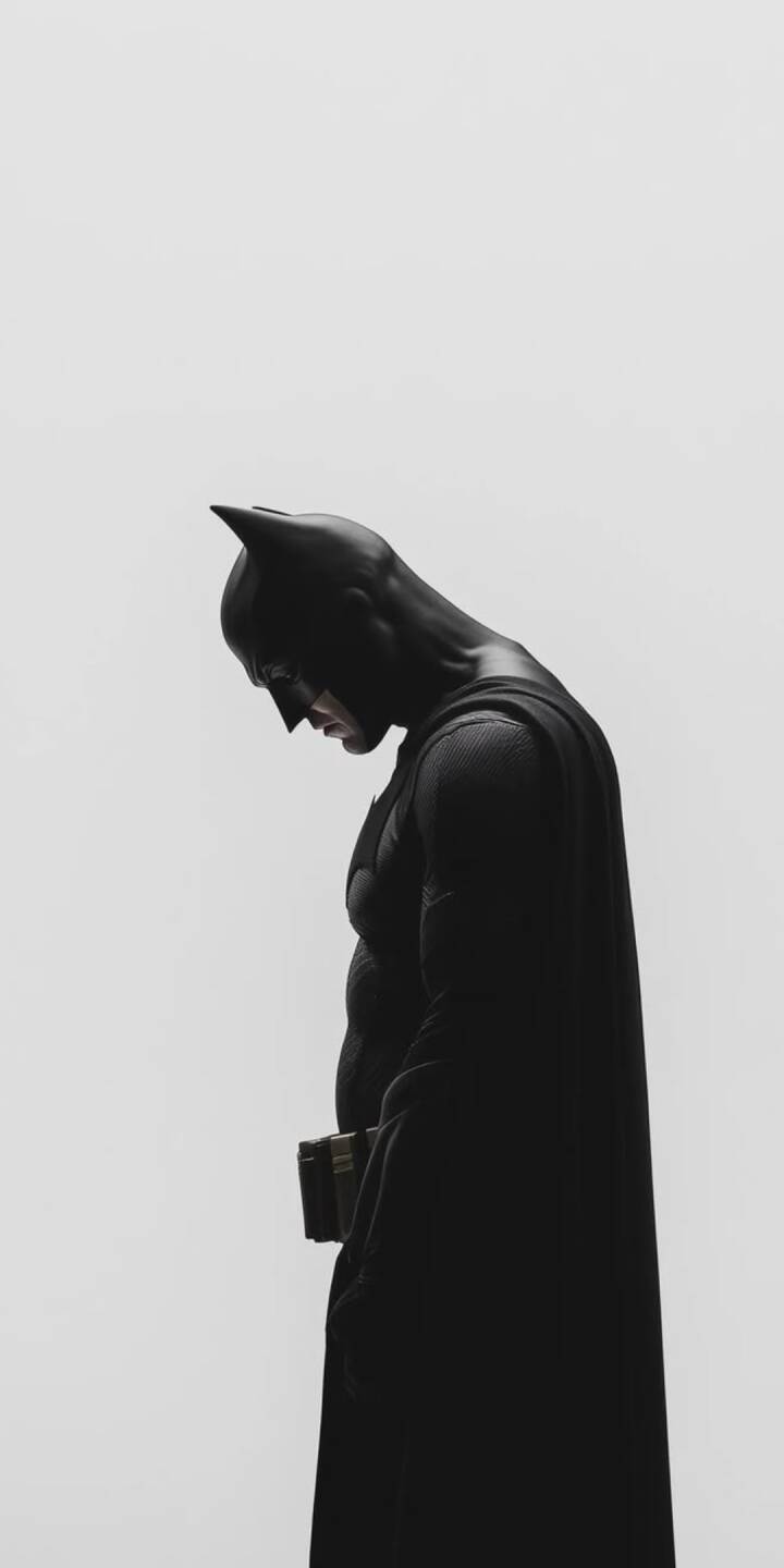 Cast in dramatic shadow, Batman's iconic silhouette, head bowed in a moment of pensive contemplation, dominates this minimalist 4K wallpaper. This atmospheric design, highlighting his textured suit and visible utility belt against a stark white background, makes a perfect brooding wallpaper for iPhone. | batman Cast in dramatic shadow, Batman's iconic silhouette, head bowed in a moment of pensive contemplation, dominates this minimalist 4K wallpaper. This atmospheric design, highlighting his textured suit and visible utility belt against a stark white background, makes a perfect brooding wallpaper for iPhone.