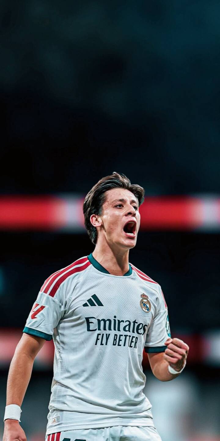 Arda Güler's intense shout of passion dominates this dynamic 4K wallpaper, capturing his vibrant celebration in a white Real Madrid jersey. This stunning football wallpaper is perfect for any iPhone, bringing the energy of the match to your screen. | sports football celebration iphone real madrid wallpaper mobile arda güler 4k wallpaper hd wallpaper energetic Arda Güler's intense shout of passion dominates this dynamic 4K wallpaper, capturing his vibrant celebration in a white Real Madrid jersey. This stunning football wallpaper is perfect for any iPhone, bringing the energy of the match to your screen.