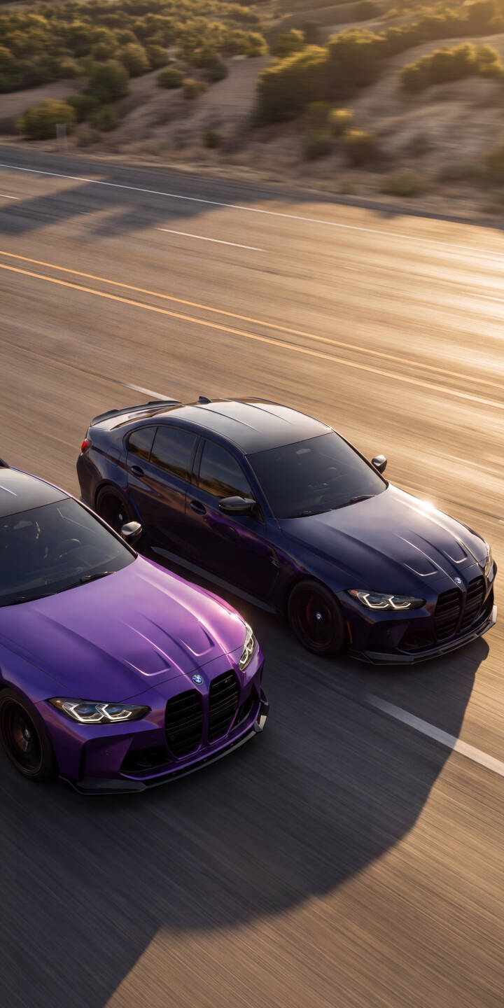 Golden hour sunlight bathes two sleek BMW M cars in rich purple and dark blue hues, creating a dynamic 4K wallpaper perfect for iPhone users. This stunning high-performance vehicle wallpaper captures them cruising a scenic road against distant hills. | aesthetic sports car iphone bmw wallpaper mobile golden hour purple car 4k wallpaper hd wallpaper automotive bmw m Golden hour sunlight bathes two sleek BMW M cars in rich purple and dark blue hues, creating a dynamic 4K wallpaper perfect for iPhone users. This stunning high-performance vehicle wallpaper captures them cruising a scenic road against distant hills.