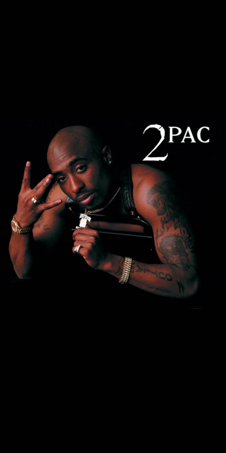 An intense gaze meets the viewer as 2Pac showcases his iconic West Side hand gesture and distinctive gold chain, making this compelling 4K wallpaper an essential mobile wallpaper for any iPhone. | artist An intense gaze meets the viewer as 2Pac showcases his iconic West Side hand gesture and distinctive gold chain, making this compelling 4K wallpaper an essential mobile wallpaper for any iPhone.