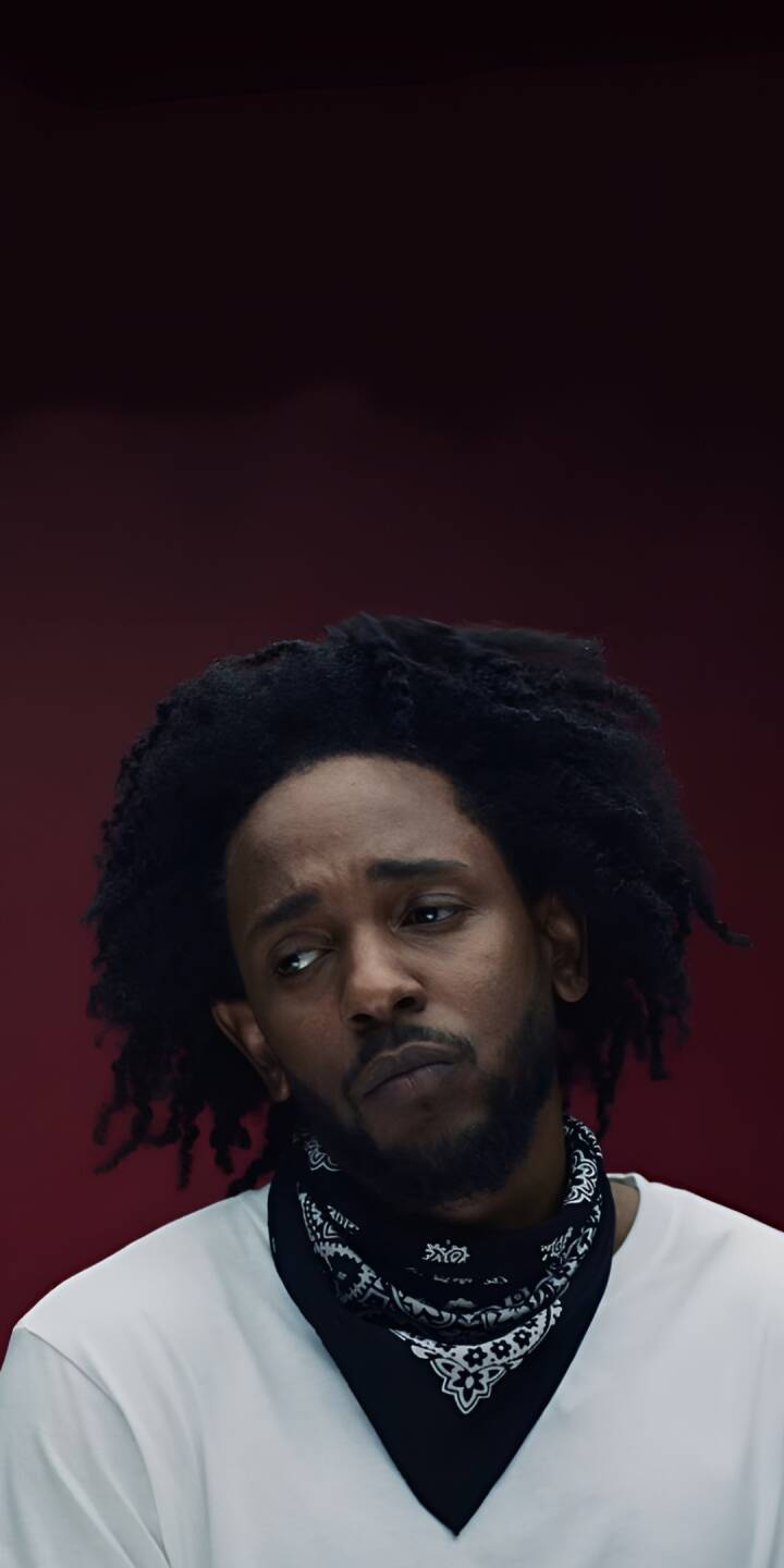 Kendrick Lamar's thoughtful expression and distinctive black bandana pop against the dark red background in this striking 4K wallpaper, making it an essential iPhone wallpaper for fans. | artist Kendrick Lamar's thoughtful expression and distinctive black bandana pop against the dark red background in this striking 4K wallpaper, making it an essential iPhone wallpaper for fans.