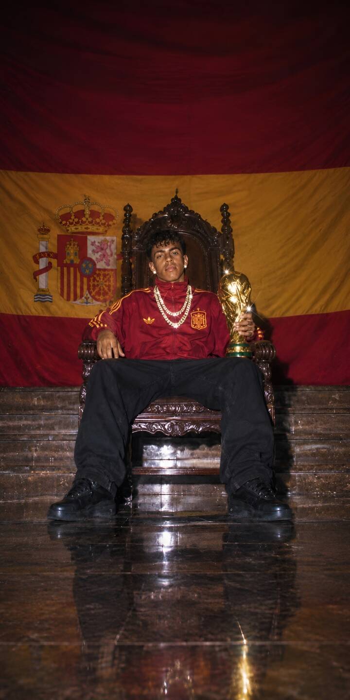 A regal Gavi sits proudly on an ornate throne, cradling the shining World Cup trophy against the backdrop of the Spanish flag in this stunning 4K wallpaper — an essential wallpaper for iPhone showcasing triumph. | 4k spain lamine yamal fifa world cup A regal Gavi sits proudly on an ornate throne, cradling the shining World Cup trophy against the backdrop of the Spanish flag in this stunning 4K wallpaper — an essential wallpaper for iPhone showcasing triumph.