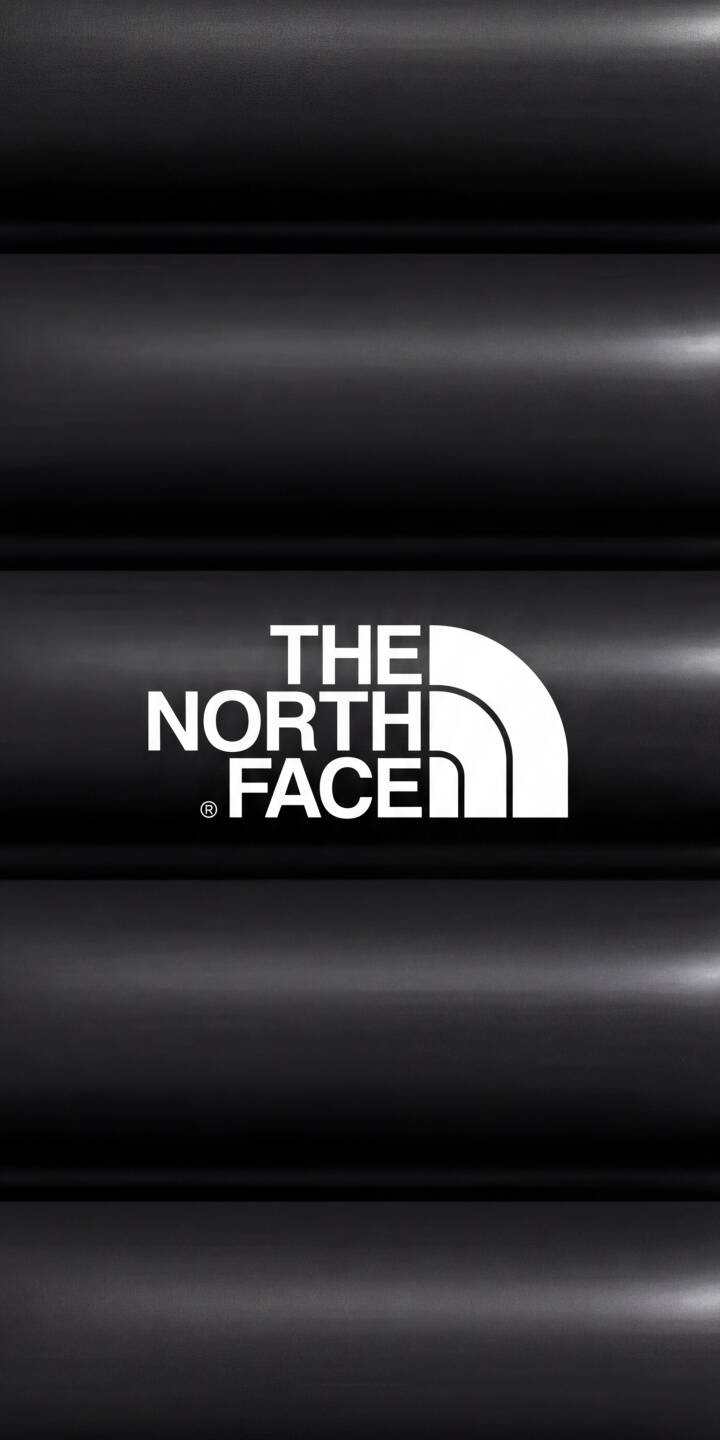 Bold white typography of The North Face logo stands out against a sleek, dark black padded texture in this striking 4K wallpaper. This iconic brand wallpaper with its subtle light reflections makes for an instantly recognizable iPhone background. | aesthetic black logo iphone minimalist wallpaper the north face mobile 4k wallpaper hd wallpaper tnf outdoor brand Bold white typography of The North Face logo stands out against a sleek, dark black padded texture in this striking 4K wallpaper. This iconic brand wallpaper with its subtle light reflections makes for an instantly recognizable iPhone background.