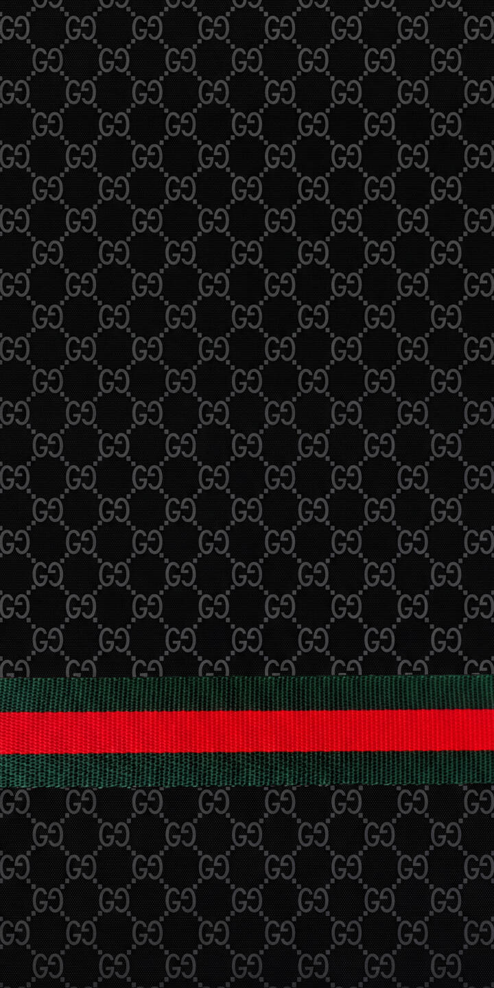 A vibrant red and green Web stripe dramatically cuts through a sophisticated dark black background adorned with a subtle interlocking GG monogram, creating a premium 4K Gucci wallpaper that is perfect for any iPhone. | iphone luxury wallpaper gucci mobile 4k wallpaper hd wallpaper black aesthetic monogram pattern fashion brand gucci wallpaper web stripe A vibrant red and green Web stripe dramatically cuts through a sophisticated dark black background adorned with a subtle interlocking GG monogram, creating a premium 4K Gucci wallpaper that is perfect for any iPhone.