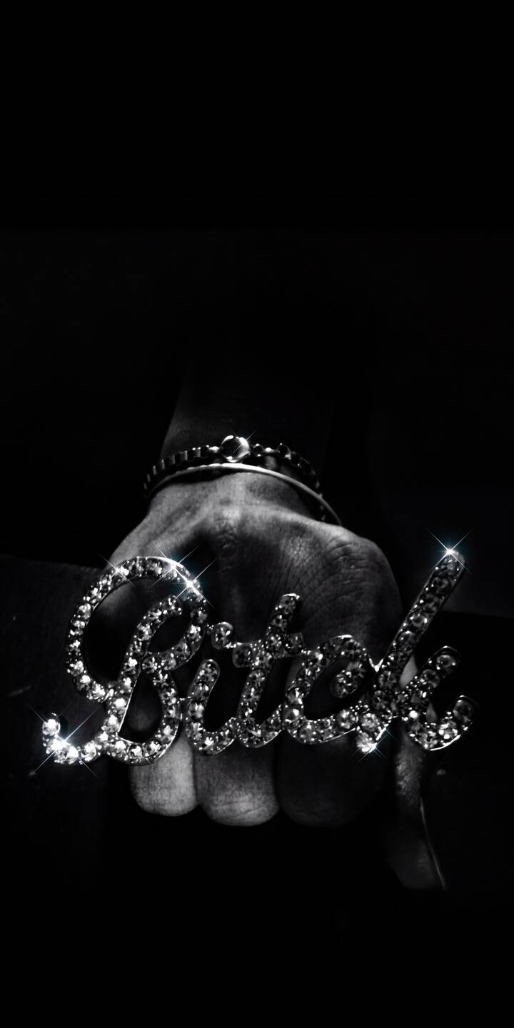Dazzling diamonds spell out 'Bitch' on a prominent ring worn by a clenched fist against a minimalist dark background, creating a bold 4K wallpaper perfect for your iPhone screen. This striking wallpaper is for those who appreciate a blend of edgy aesthetics and luxurious sparkle. | hand diamond iphone wallpaper sparkling mobile 4k wallpaper hd wallpaper dark aesthetic edgy gritty bitch ring Dazzling diamonds spell out 'Bitch' on a prominent ring worn by a clenched fist against a minimalist dark background, creating a bold 4K wallpaper perfect for your iPhone screen. This striking wallpaper is for those who appreciate a blend of edgy aesthetics and luxurious sparkle.