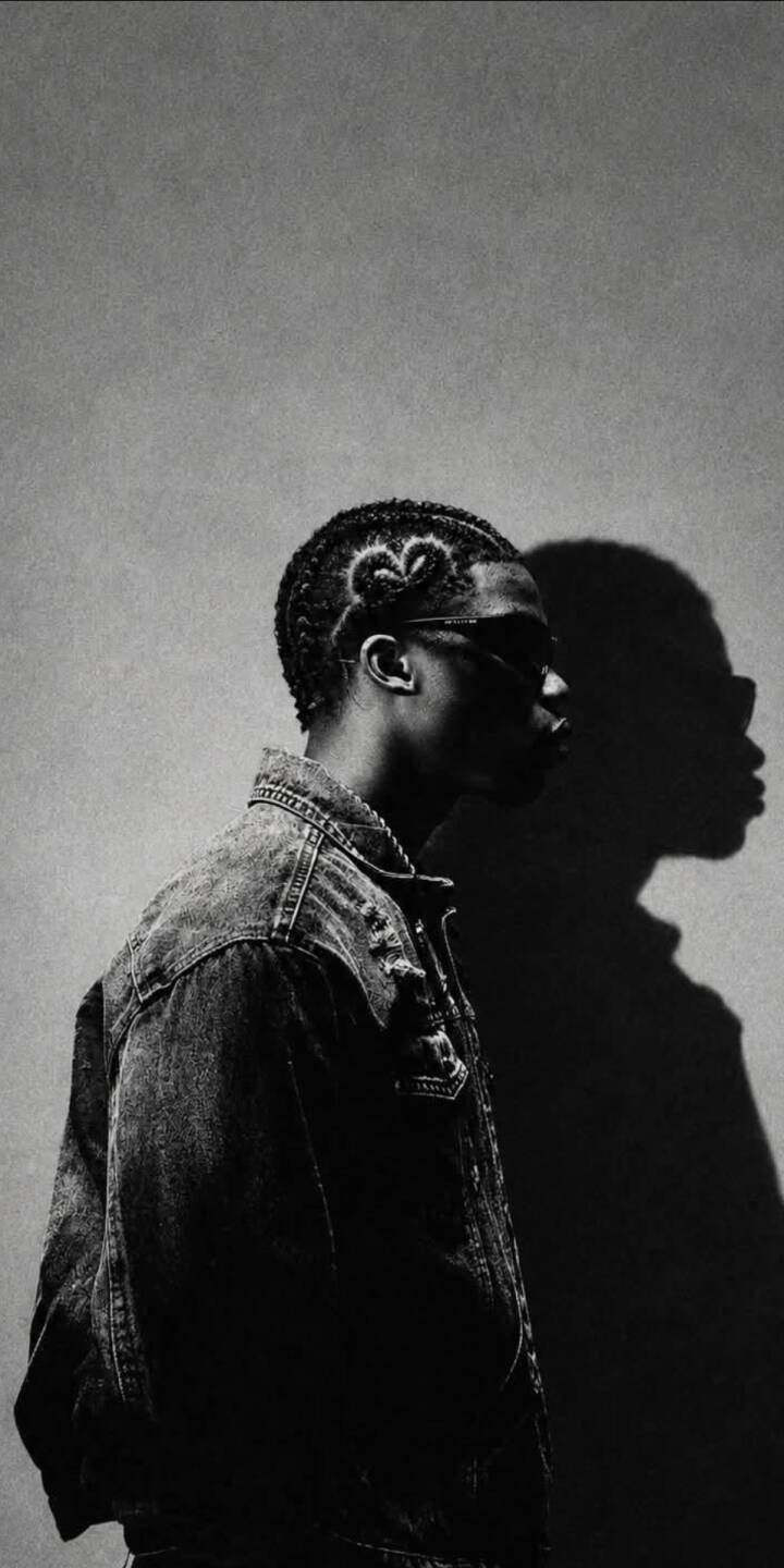 A dramatic profile shot in stark black and white captures a man with a unique heart-shaped hair design and a stylish denim jacket in this sleek 4K wallpaper. This captivating image makes an excellent mobile wallpaper for iPhone. | artist A dramatic profile shot in stark black and white captures a man with a unique heart-shaped hair design and a stylish denim jacket in this sleek 4K wallpaper. This captivating image makes an excellent mobile wallpaper for iPhone.