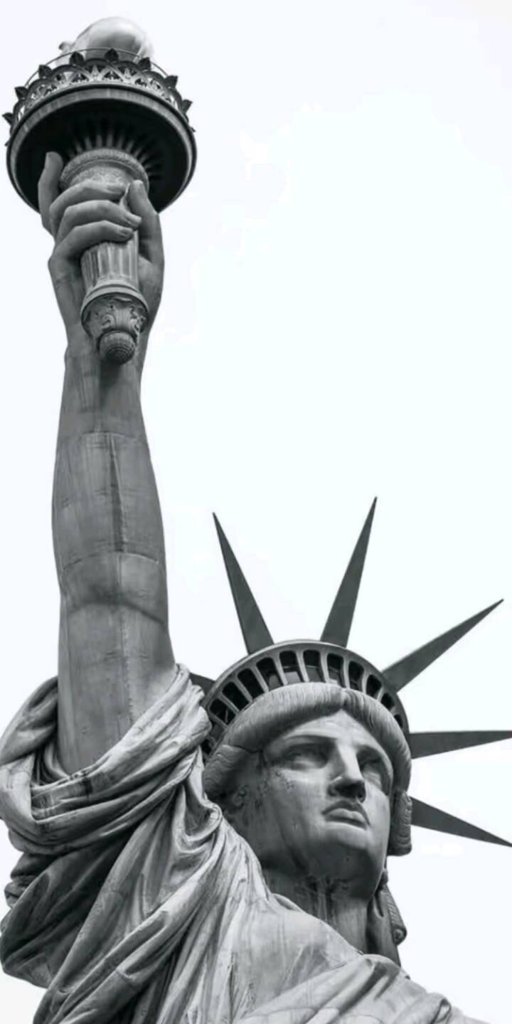 The iconic torch of Lady Liberty is held high in this striking grayscale 4K wallpaper, featuring intricate details of her face and crown; this monumental wallpaper is a perfect historical backdrop for your iPhone. | art The iconic torch of Lady Liberty is held high in this striking grayscale 4K wallpaper, featuring intricate details of her face and crown; this monumental wallpaper is a perfect historical backdrop for your iPhone.