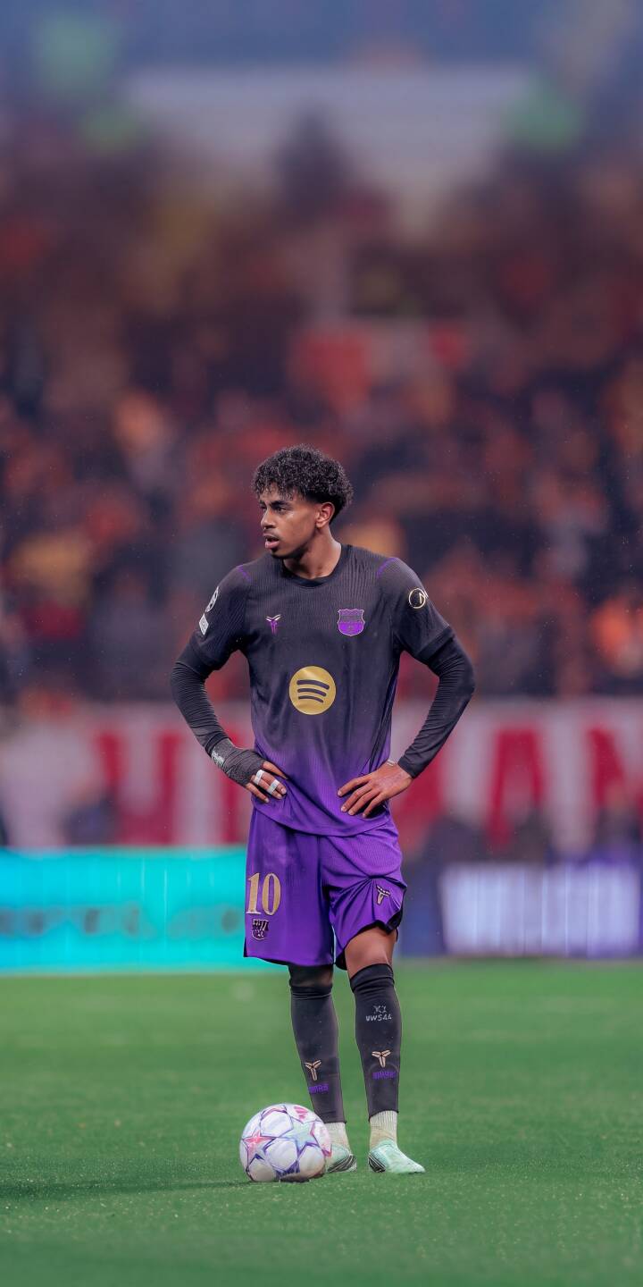 A focused soccer player wearing a stylish dark purple gradient jersey with number 10 stands ready on the vibrant green pitch beside a soccer ball, creating an immersive 4K wallpaper. This stunning wallpaper for iPhone fans perfectly captures the anticipation of the game. | sports football stadium athlete iphone wallpaper soccer player mobile 4k wallpaper hd wallpaper number 10 purple jersey A focused soccer player wearing a stylish dark purple gradient jersey with number 10 stands ready on the vibrant green pitch beside a soccer ball, creating an immersive 4K wallpaper. This stunning wallpaper for iPhone fans perfectly captures the anticipation of the game.