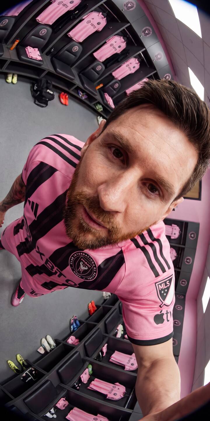 The bold pink stripes of Lionel Messi's Inter Miami jersey fill the frame as he captures a dynamic fish-eye selfie inside the team's locker room, surrounded by identical pink kits—a vibrant 4K wallpaper perfect for your iPhone. This intimate locker room wallpaper provides a unique fan perspective. | iphone messi soccer wallpaper lionel messi mobile inter miami 4k wallpaper hd wallpaper pink jersey locker room The bold pink stripes of Lionel Messi's Inter Miami jersey fill the frame as he captures a dynamic fish-eye selfie inside the team's locker room, surrounded by identical pink kits—a vibrant 4K wallpaper perfect for your iPhone. This intimate locker room wallpaper provides a unique fan perspective.