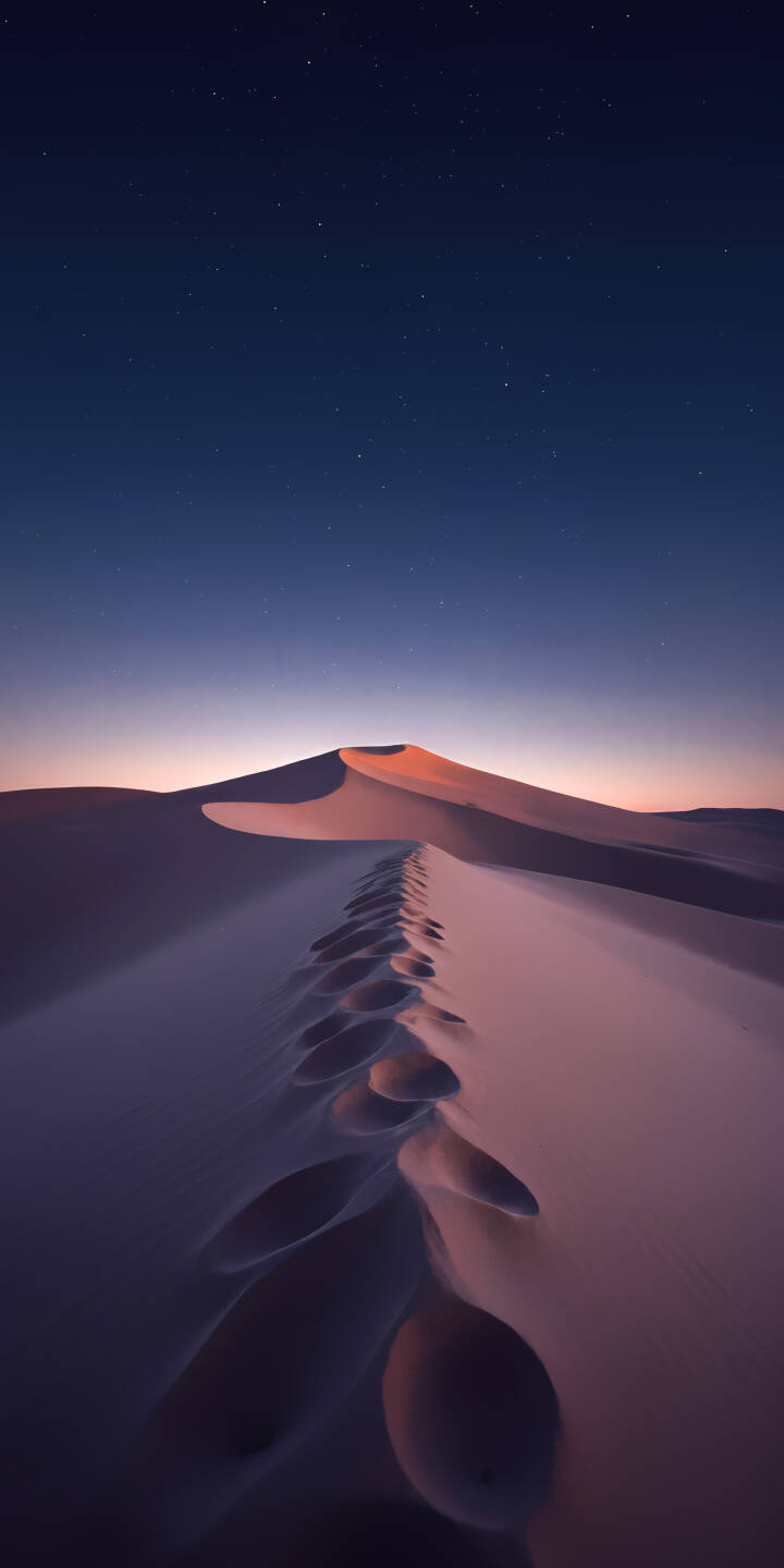 A mesmerizing trail of footprints snakes across the undulating desert dunes, bathed in the soft hues of a twilight sky dotted with distant stars. This serene 4K wallpaper makes a captivating iPhone wallpaper. | aesthetic landscape desert night sky iphone stars wallpaper mobile 4k wallpaper hd wallpaper dunes footprints A mesmerizing trail of footprints snakes across the undulating desert dunes, bathed in the soft hues of a twilight sky dotted with distant stars. This serene 4K wallpaper makes a captivating iPhone wallpaper.