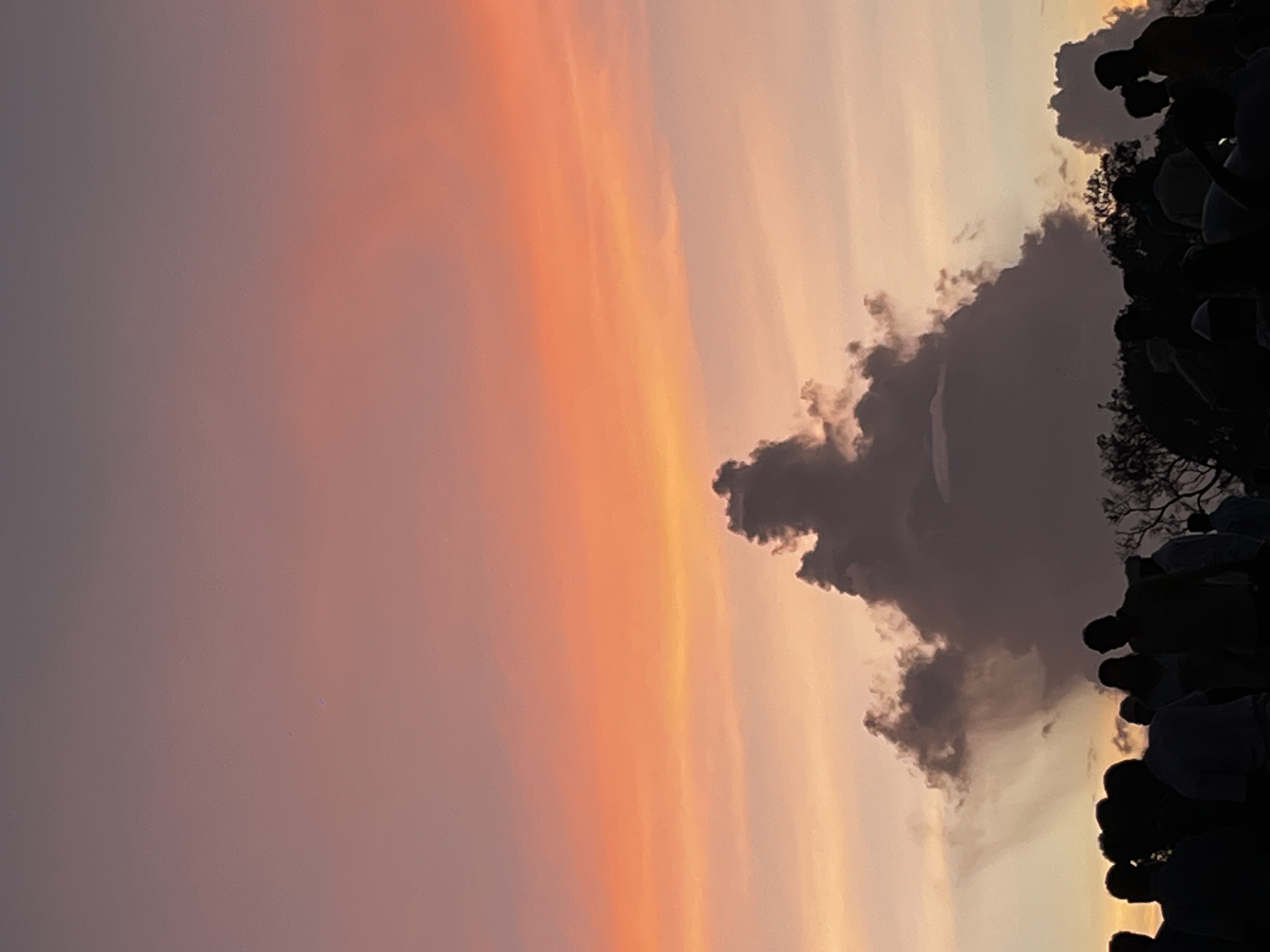 sunset sky filled with warm orange, pink, and purple gradients, contrasted by dramatic cloud formations and silhouetted onlookers | sky cloud nature vibe sunset sky filled with warm orange, pink, and purple gradients, contrasted by dramatic cloud formations and silhouetted onlookers